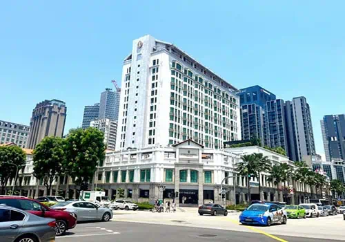 Bugis Junction shopping centre, a white colonial-style building at a busy junction